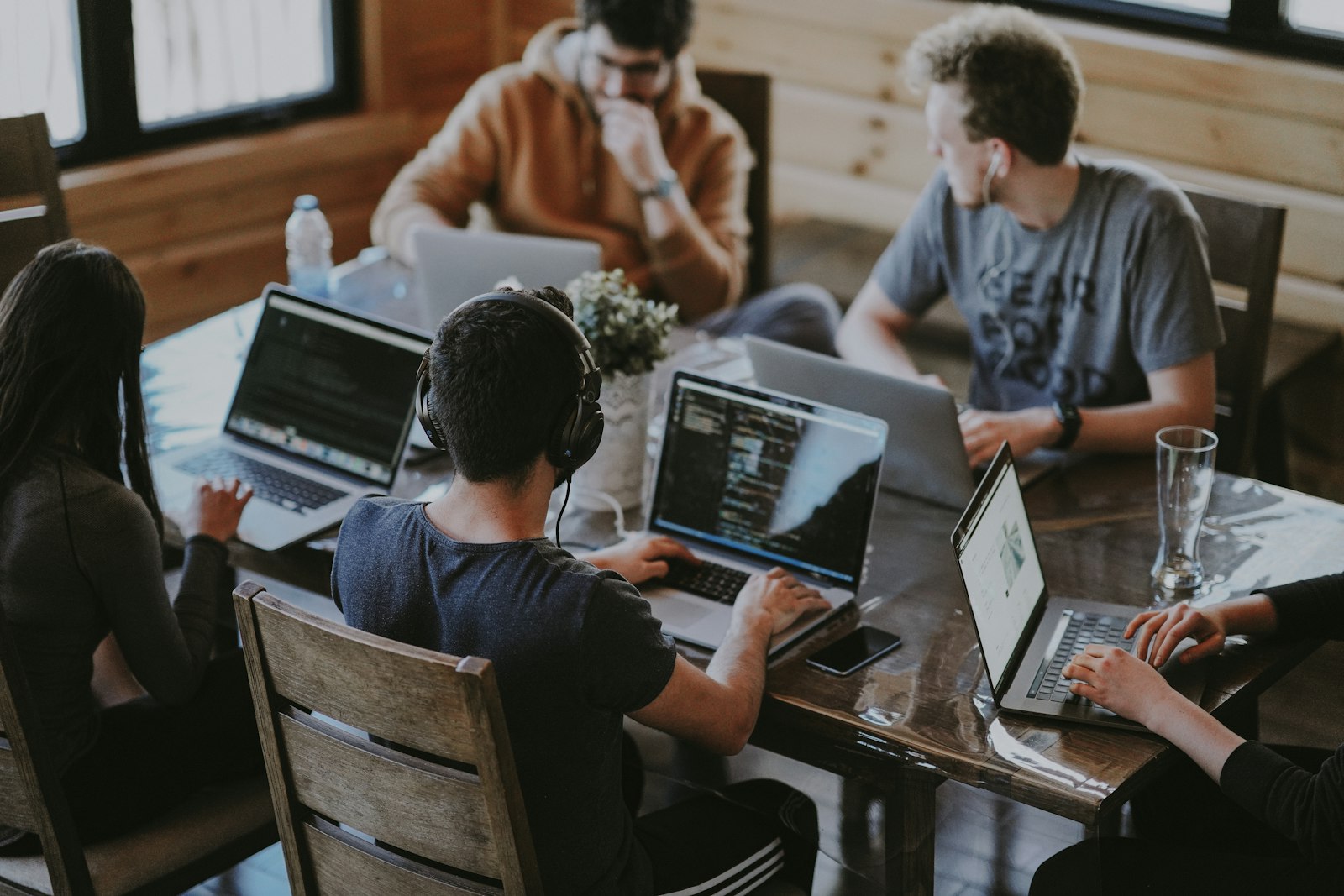 A team working across laptops at a shared table