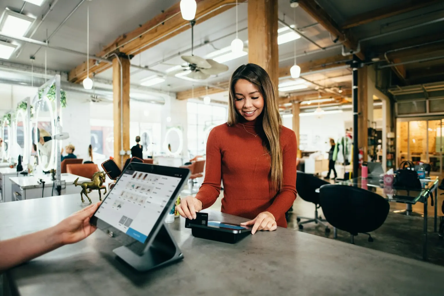 A customer paying at a salon counter